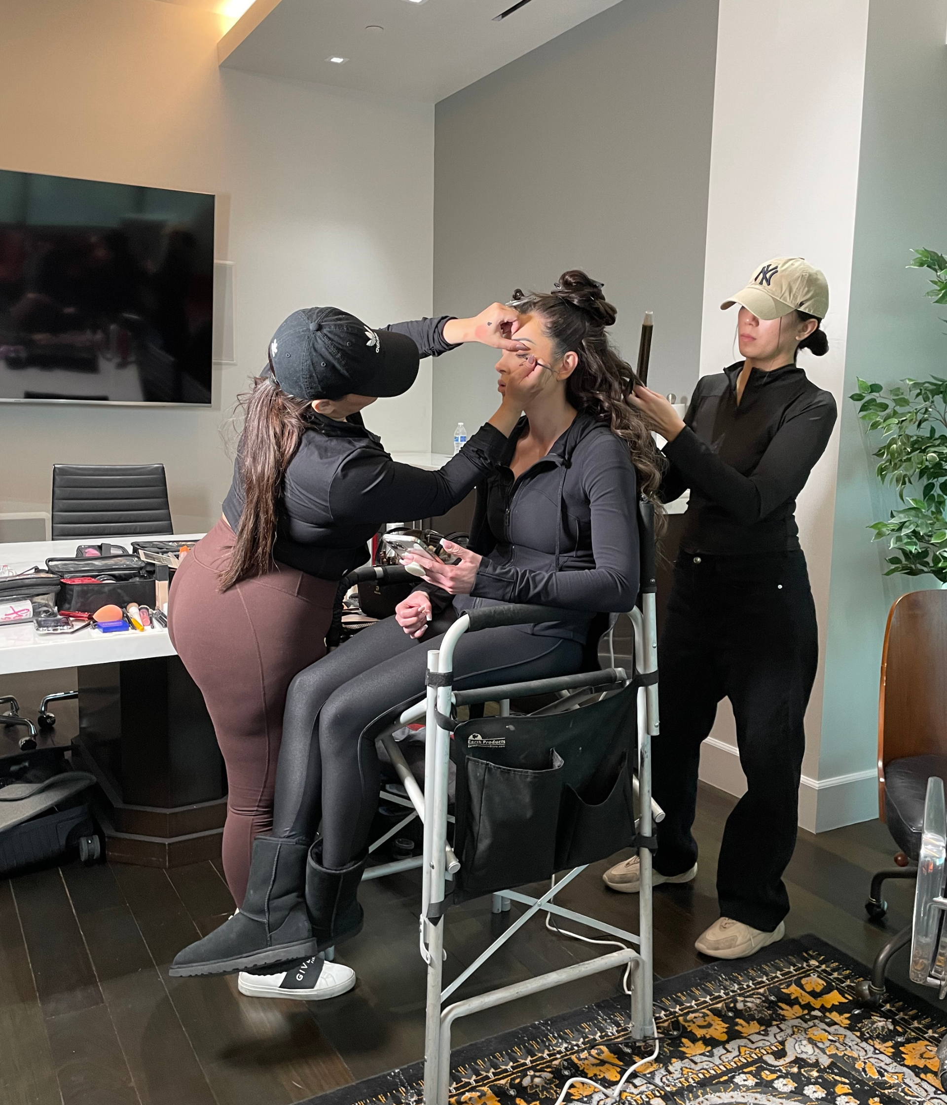 A stylist performing a live hairstyle application on a real client